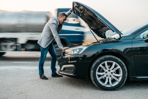 Workshop professional testing a car battery